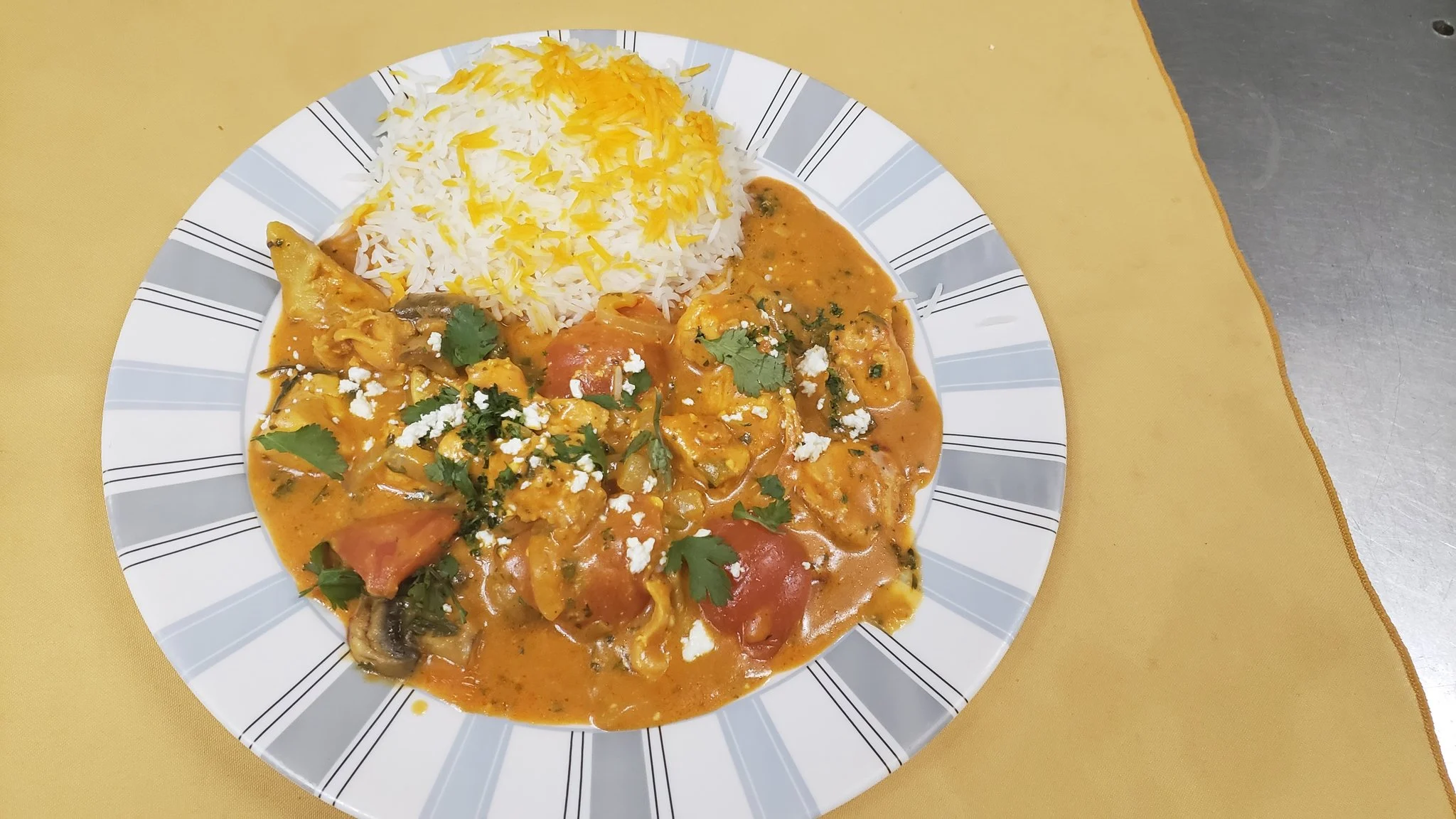 Chicken Panir Sabzi in feta and herb sauce, served with basmati rice